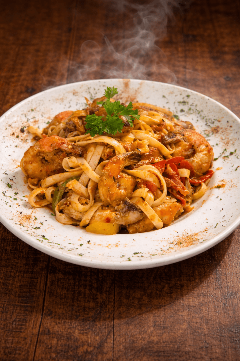 MOV Cajun Pasta with shrimp, sausage, peppers, and fettuccine in a white bowl